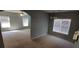Dining area featuring large windows and neutral wall paint, with an open view to the living area at 8628 Thomas Rd, Riverdale, GA 30274