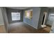 Dining area features a large window, a chandelier, and an open view into the kitchen at 8628 Thomas Rd, Riverdale, GA 30274
