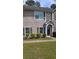 Traditional brick townhouse with neat landscaping and a charming front entrance at 8628 Thomas Rd, Riverdale, GA 30274