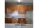 Bright kitchen featuring granite countertops and traditional wood cabinets at 8628 Thomas Rd, Riverdale, GA 30274