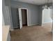 Living room featuring neutral walls, carpet flooring, and an open floorplan at 8628 Thomas Rd, Riverdale, GA 30274