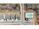 An aerial view showcases the homes, street layout, and the community pool surrounded by trees at 1501 Branthaven Ln, Auburn, GA 30011