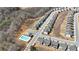 An aerial view showcases a community layout, featuring homes and a pool near a natural area at 1501 Branthaven Ln, Auburn, GA 30011