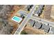 A clear aerial view shows a community pool and the surrounding homes and parking at 1501 Branthaven Ln, Auburn, GA 30011