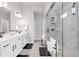 Modern bathroom with double vanity, white cabinets, and a glass-enclosed shower at 1501 Branthaven Ln, Auburn, GA 30011