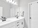 Bright bathroom features a double sink vanity with modern black fixtures and a large mirror at 1501 Branthaven Ln, Auburn, GA 30011