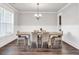 Bright dining room with a wooden table, six chairs, and a modern chandelier at 1501 Branthaven Ln, Auburn, GA 30011