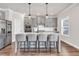 Modern kitchen featuring gray cabinets, a center island with seating, and stainless steel appliances at 1501 Branthaven Ln, Auburn, GA 30011