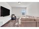 Cozy living room with a large sofa, recliner chair, and a wall-mounted television at 1501 Branthaven Ln, Auburn, GA 30011