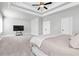 Expansive main bedroom featuring carpet flooring, a ceiling fan, and a king-size bed at 1501 Branthaven Ln, Auburn, GA 30011