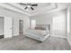 Spacious main bedroom with tray ceilings, carpet flooring, and large windows at 1501 Branthaven Ln, Auburn, GA 30011
