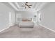 Spacious main bedroom featuring tray ceilings, neutral tones, and carpet flooring at 1501 Branthaven Ln, Auburn, GA 30011