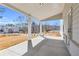 Wide covered patio featuring elegant support columns and peaceful views of the backyard and surroundings at 1501 Branthaven Ln, Auburn, GA 30011