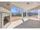 Covered patio featuring a cozy fireplace and scenic views of the surrounding landscape at 1501 Branthaven Ln, Auburn, GA 30011