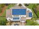 Aerial view of the backyard shows the solar panels, patio and lush surroundings at 332 Chaffin Rd, Roswell, GA 30075
