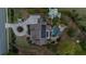 Stunning aerial view showcases the property's landscaped grounds, private pool, and circular driveway with central garden at 332 Chaffin Rd, Roswell, GA 30075