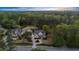Beautiful aerial view of a home in a lush, wooded setting, featuring a well-maintained lawn and mature trees at 332 Chaffin Rd, Roswell, GA 30075