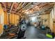 Basement gym with various workout equipment; features unfinished ceiling with exposed beams and insulated walls at 332 Chaffin Rd, Roswell, GA 30075