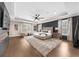 Spacious bedroom with hardwood floors, a textured wall, and a ceiling fan at 332 Chaffin Rd, Roswell, GA 30075