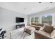 Comfortable bonus room with a sectional sofa and large television is great for entertainment at 332 Chaffin Rd, Roswell, GA 30075
