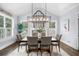 Elegant dining room with a modern chandelier, large windows, and seating for six at 332 Chaffin Rd, Roswell, GA 30075