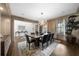 Dining room with modern chandelier, large table, decorative rug and view to front entry hall at 332 Chaffin Rd, Roswell, GA 30075