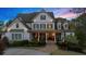 Charming two-story home with white siding, a manicured lawn, and a welcoming front porch at 332 Chaffin Rd, Roswell, GA 30075