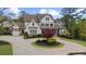 Charming two-story home with white siding, a circular driveway, and meticulously landscaped grounds at 332 Chaffin Rd, Roswell, GA 30075