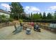 Backyard seating area with natural stone and a fire pit perfect for outdoor gatherings at 332 Chaffin Rd, Roswell, GA 30075
