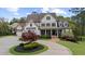 Charming home with manicured landscaping, a circular driveway, and a welcoming front porch at 332 Chaffin Rd, Roswell, GA 30075