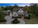 Two-story traditional home with a manicured lawn and inviting front porch highlighted by the evening twilight at 332 Chaffin Rd, Roswell, GA 30075