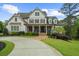 Inviting two-story traditional home with manicured lawn, circular driveway, and a charming front porch at 332 Chaffin Rd, Roswell, GA 30075