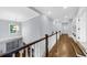Second-floor hallway featuring a charming chandelier and staircase that leads to the first floor at 332 Chaffin Rd, Roswell, GA 30075