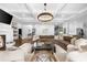 Open-concept living room with fireplace, large sofa, and seamless flow to the kitchen at 332 Chaffin Rd, Roswell, GA 30075