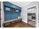 Well-organized mudroom with custom blue cabinetry, bench seating, and storage at 332 Chaffin Rd, Roswell, GA 30075