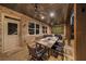 Covered patio area with brick walls, ceiling fan, and a large dining table with seating for eight at 332 Chaffin Rd, Roswell, GA 30075