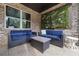 Inviting outdoor patio featuring comfortable seating, a coffee table, and a brick wall at 332 Chaffin Rd, Roswell, GA 30075