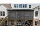A multi-level patio showing furniture, a screened-in room and an open air patio with grill at 332 Chaffin Rd, Roswell, GA 30075