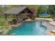Beautiful backyard pool with swim up bar, covered outdoor kitchen, and lush landscaping at 332 Chaffin Rd, Roswell, GA 30075