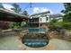 Back of house showcasing the pool with a water feature, bar and an outdoor seating area at 332 Chaffin Rd, Roswell, GA 30075