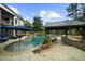 Backyard with in-ground pool, outdoor kitchen, covered cabana, and lounge chairs at 332 Chaffin Rd, Roswell, GA 30075