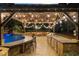 Outdoor kitchen and bar area with a built-in grill and seating, adjacent to the pool area at 332 Chaffin Rd, Roswell, GA 30075
