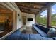 Inviting covered porch featuring wood beams, string lights, and comfortable seating area at 332 Chaffin Rd, Roswell, GA 30075