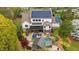 Expansive backyard featuring a pool, spa, screened porch, and solar panels for energy efficiency at 332 Chaffin Rd, Roswell, GA 30075