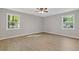 Spacious primary bedroom boasts hardwood floors and lots of natural light from dual windows at 4718 Lou Ivy Rd, Peachtree Corners, GA 30096
