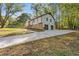 Long concrete driveway leading to the home with an attached two-car garage at 4718 Lou Ivy Rd, Peachtree Corners, GA 30096