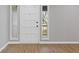 Bright entryway with light gray walls, wood-look floors, and a white front door at 4718 Lou Ivy Rd, Peachtree Corners, GA 30096