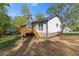 Exterior view of a home with a large deck and landscaped backyard at 4718 Lou Ivy Rd, Peachtree Corners, GA 30096