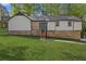 Charming home with a stone foundation, a bright blue front door, and a lush green lawn at 4718 Lou Ivy Rd, Peachtree Corners, GA 30096