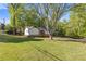 Charming home with a stone foundation, a bright blue front door, and a spacious front lawn at 4718 Lou Ivy Rd, Peachtree Corners, GA 30096